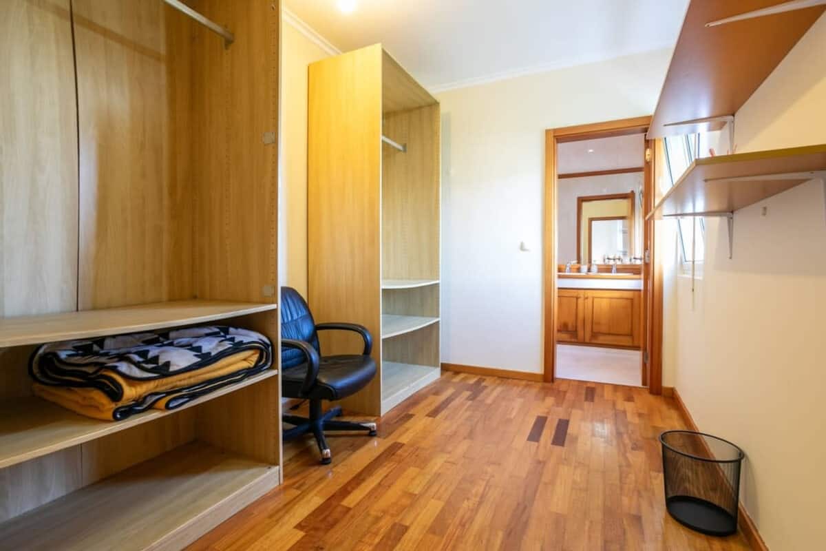 Walk-in dressing area with wardrobes leading to a bathroom